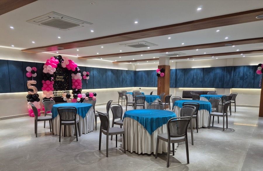 the banquet hall at Hotel Shera, Raipur, set for a birthday with a balloon arch at the far end
