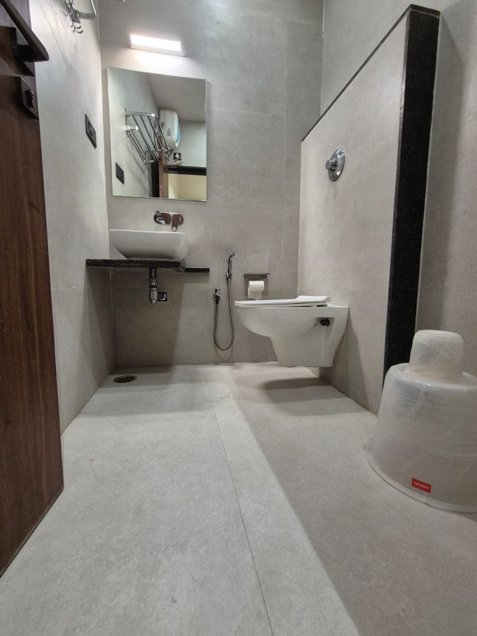A room bathroom with a walk-in shower area and modern fittings
