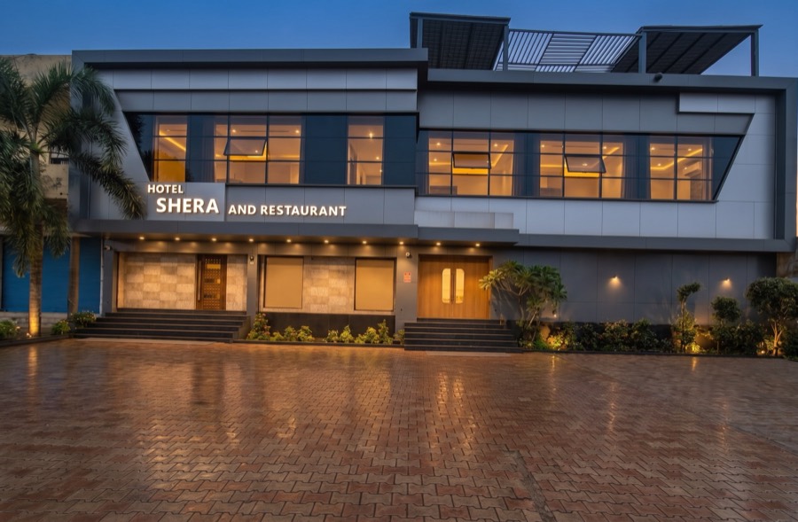 Hotel Shera and Restaurant, Bilaspur Road, Raipur — the front and forecourt at dusk