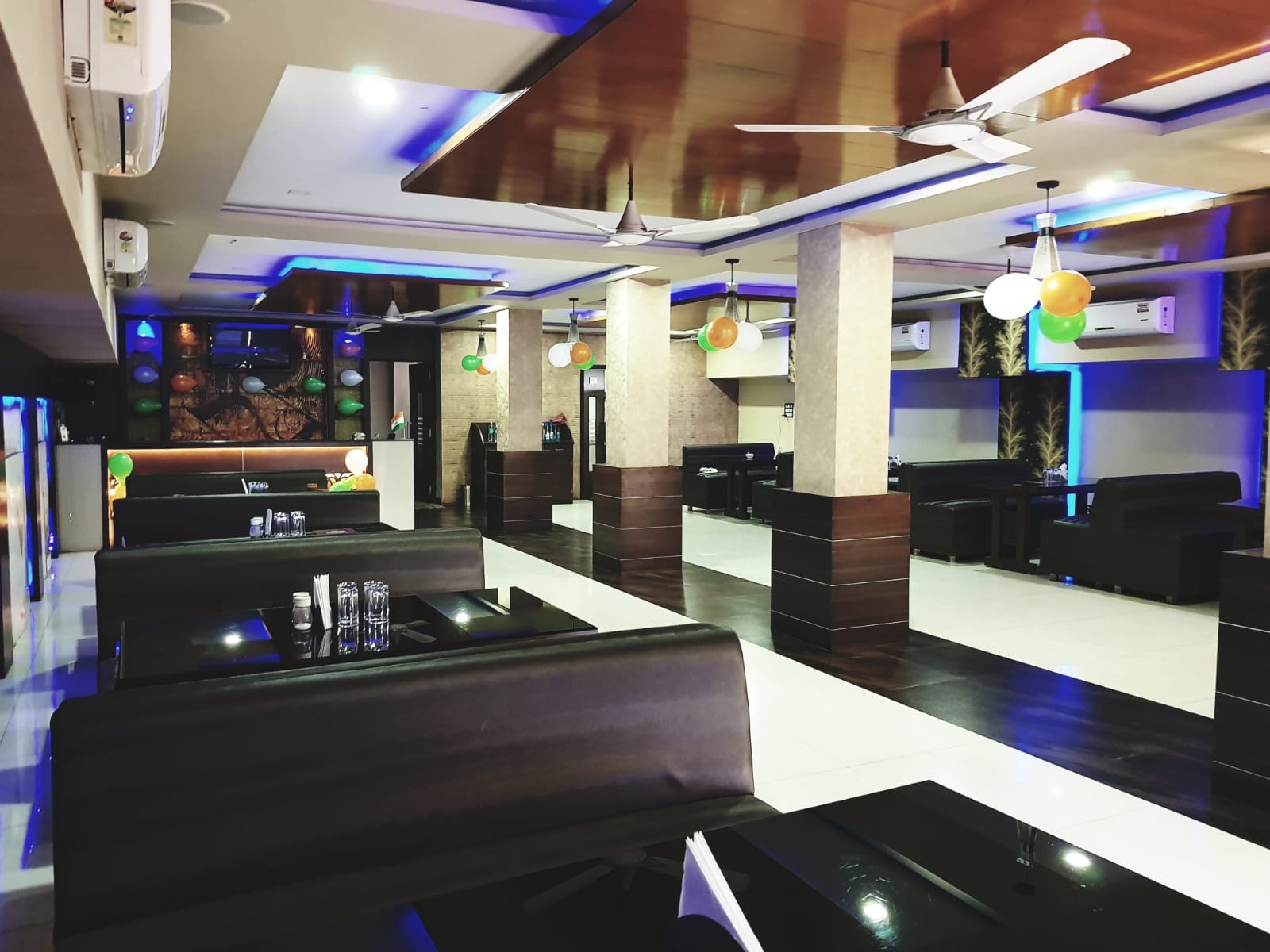 The indoor dining hall with booth seating and accent lighting